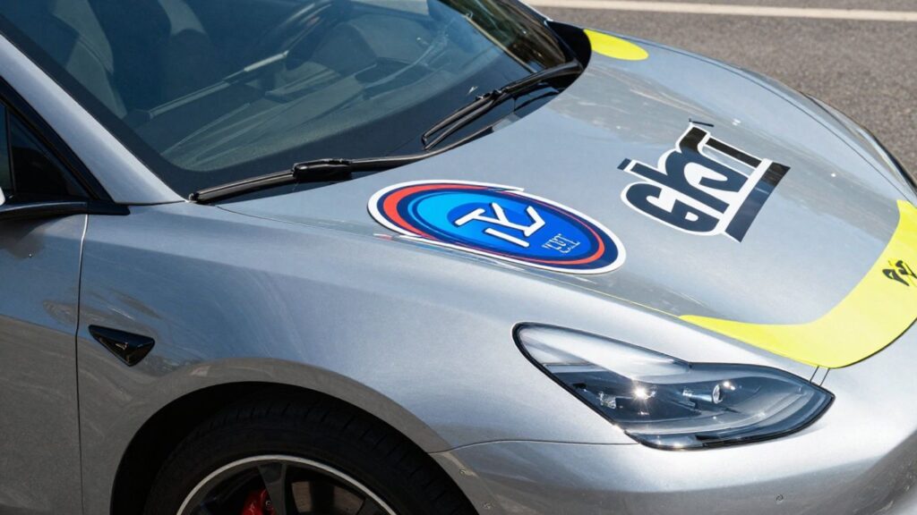 Car with vibrant business stickers in the UK.